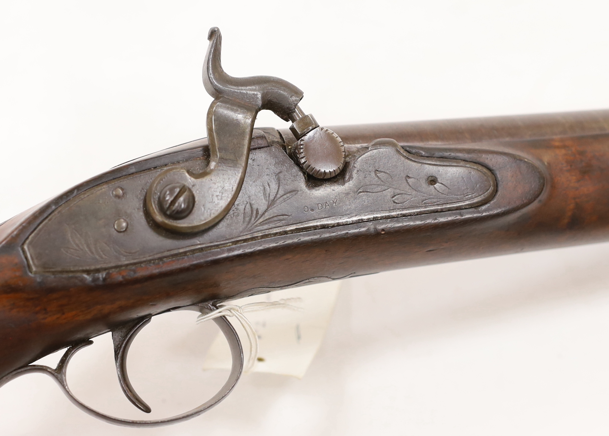 A pair of 12 bore percussion pistols converted from percussion sporting guns, round twist barrels, locks stamped G. Day, iron mounts with nickel fore-end caps and chequered grips